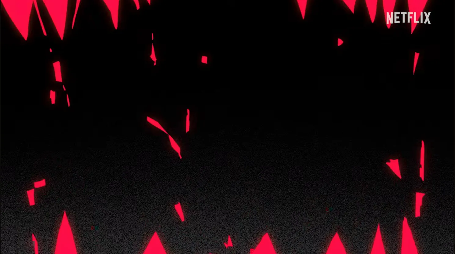 Red jagged triangles bordering a black screen